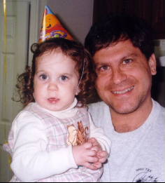 A person holding a baby

Description automatically generated