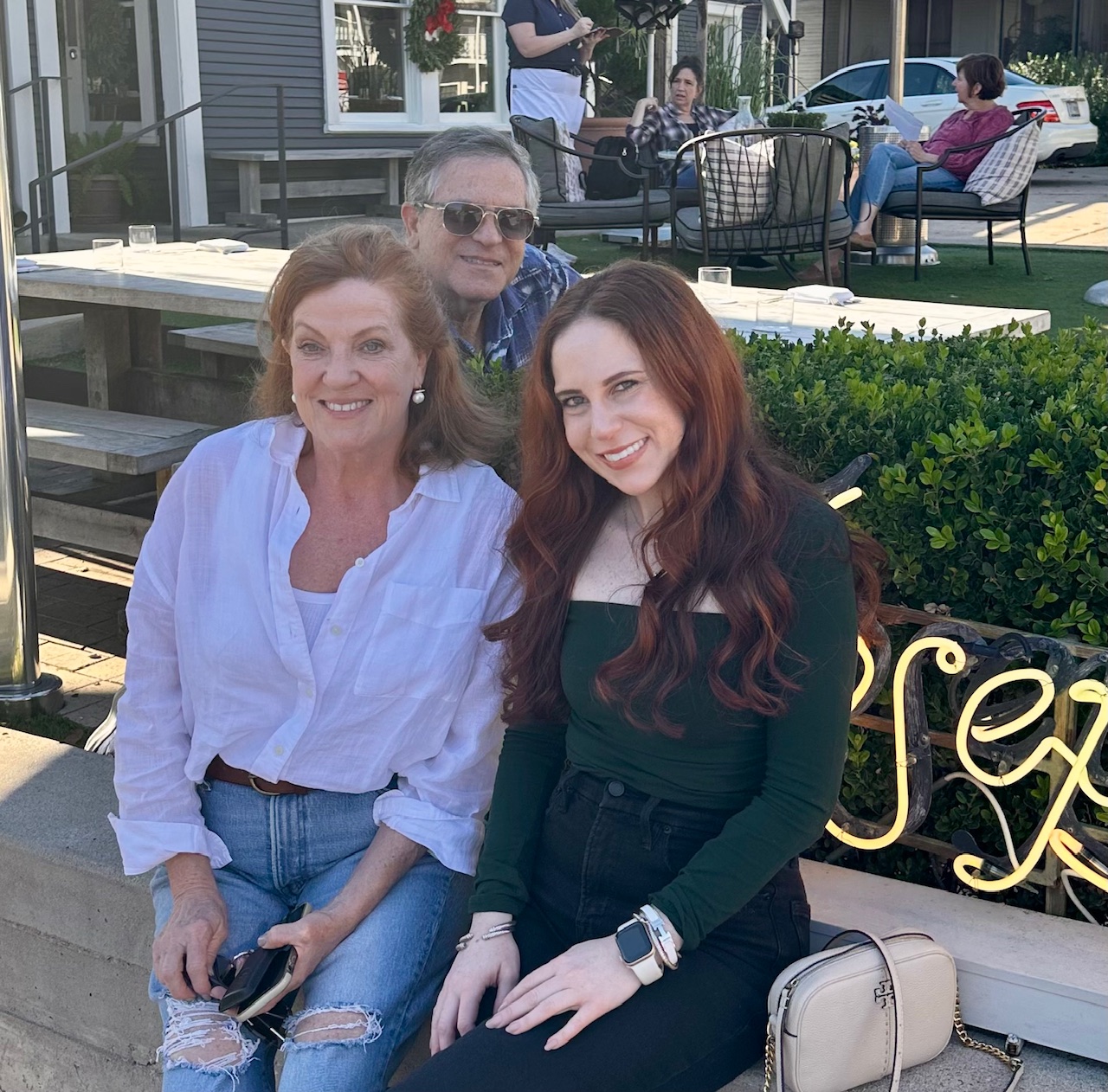 A group of people sitting on a bench

Description automatically generated