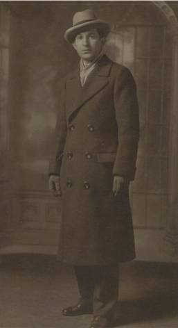 A person in a long coat

Description automatically generated