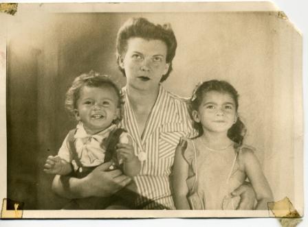 A person holding two children

Description automatically generated