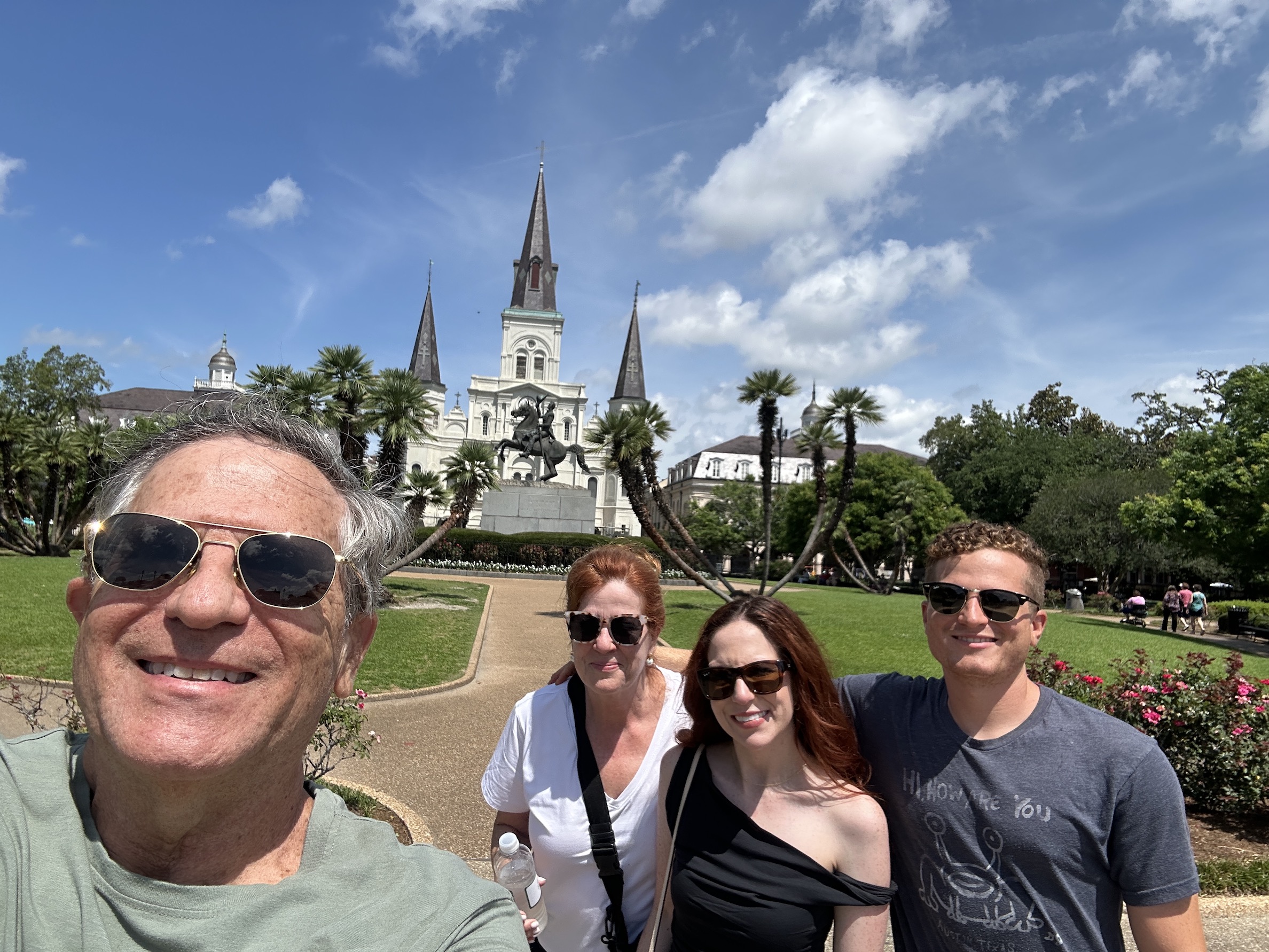 A group of people posing for a photo in front of a building
Description automatically generated