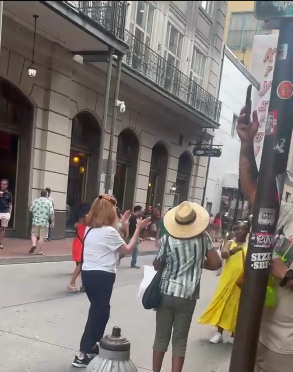 A group of people on a street
Description automatically generated