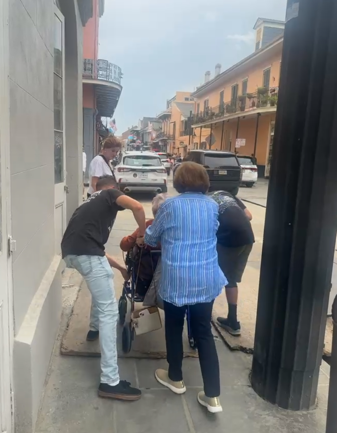 A group of people pushing a stroller
Description automatically generated