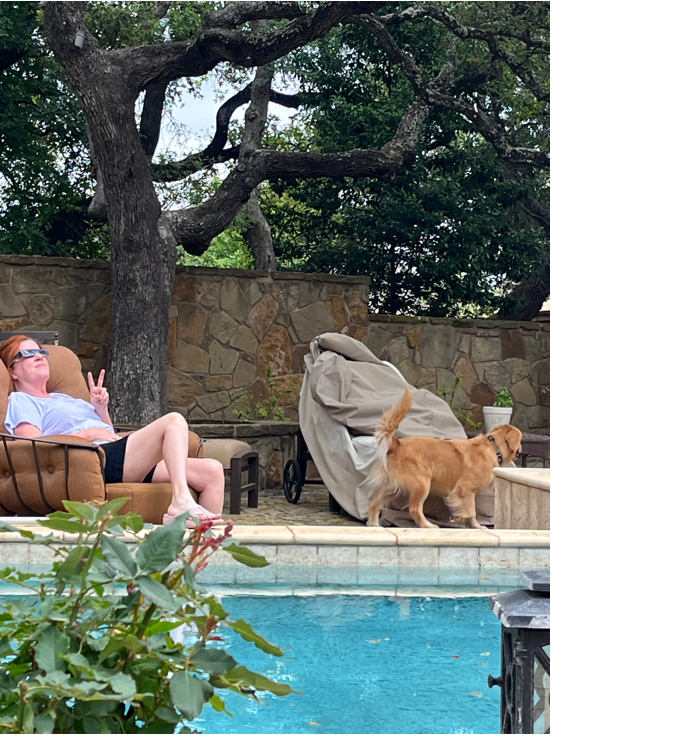 A person and dog by a pool

Description automatically generated