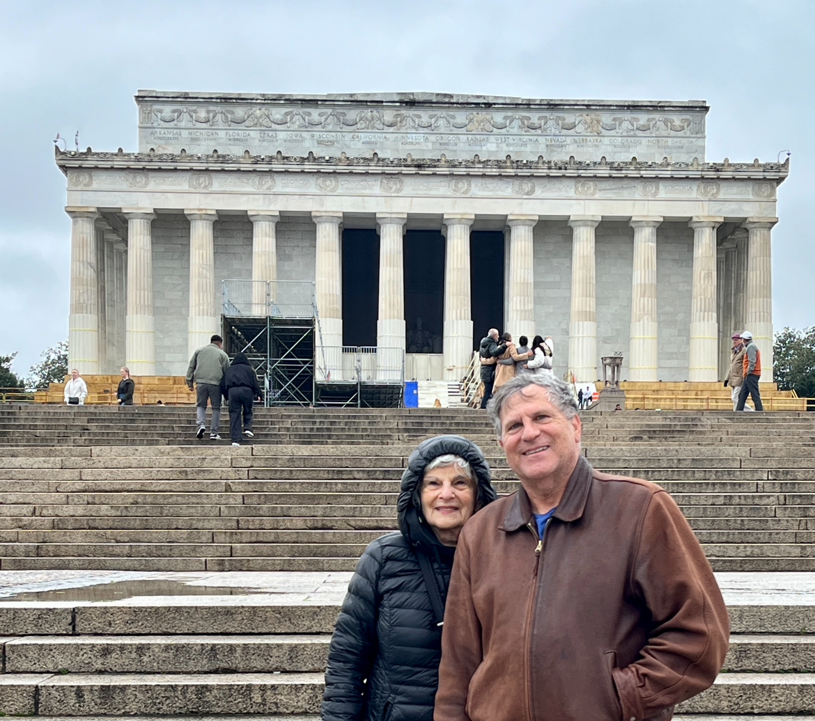 A person and person standing in front of Lincoln Memorial

Description automatically generated