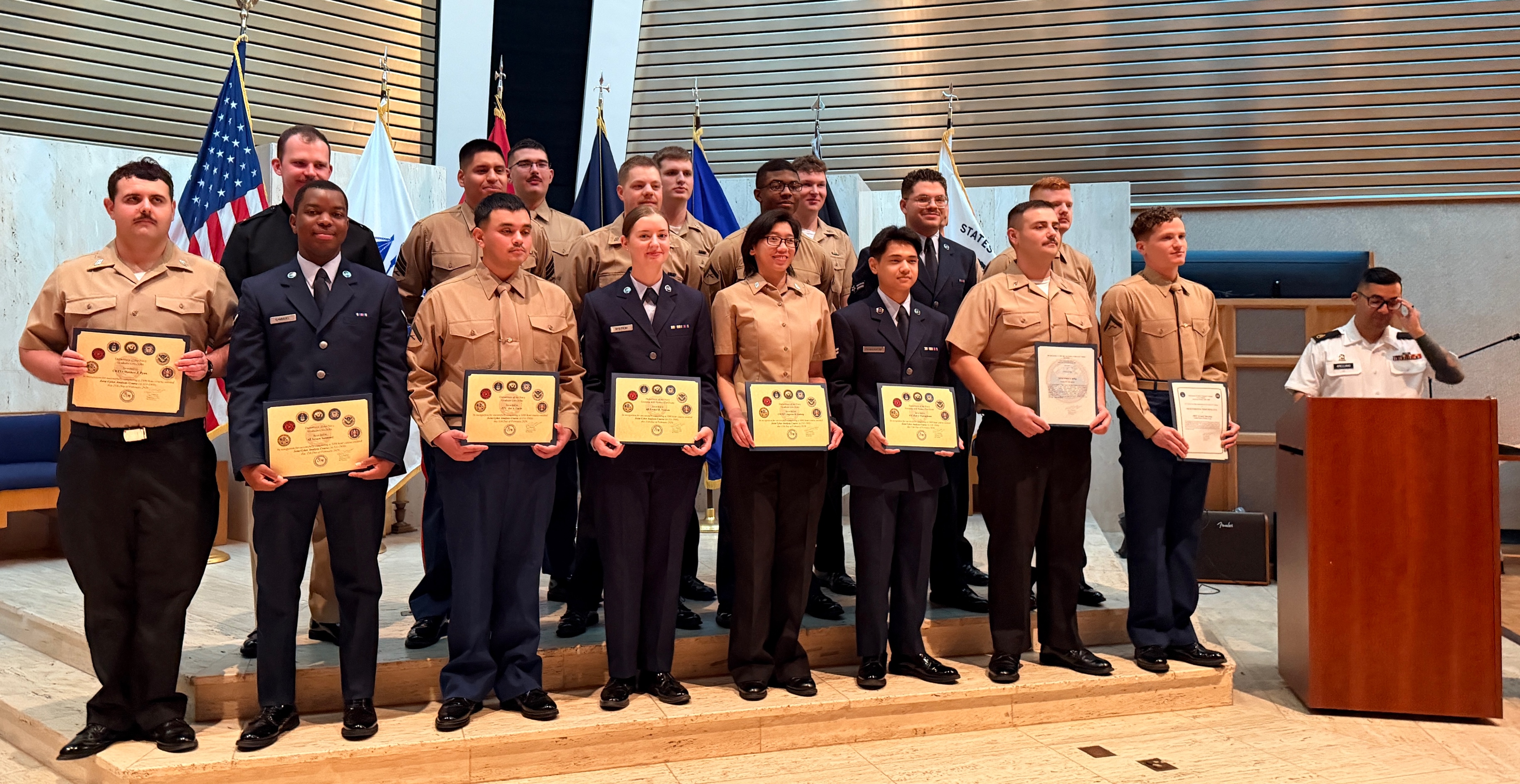 A group of people holding certificates

Description automatically generated