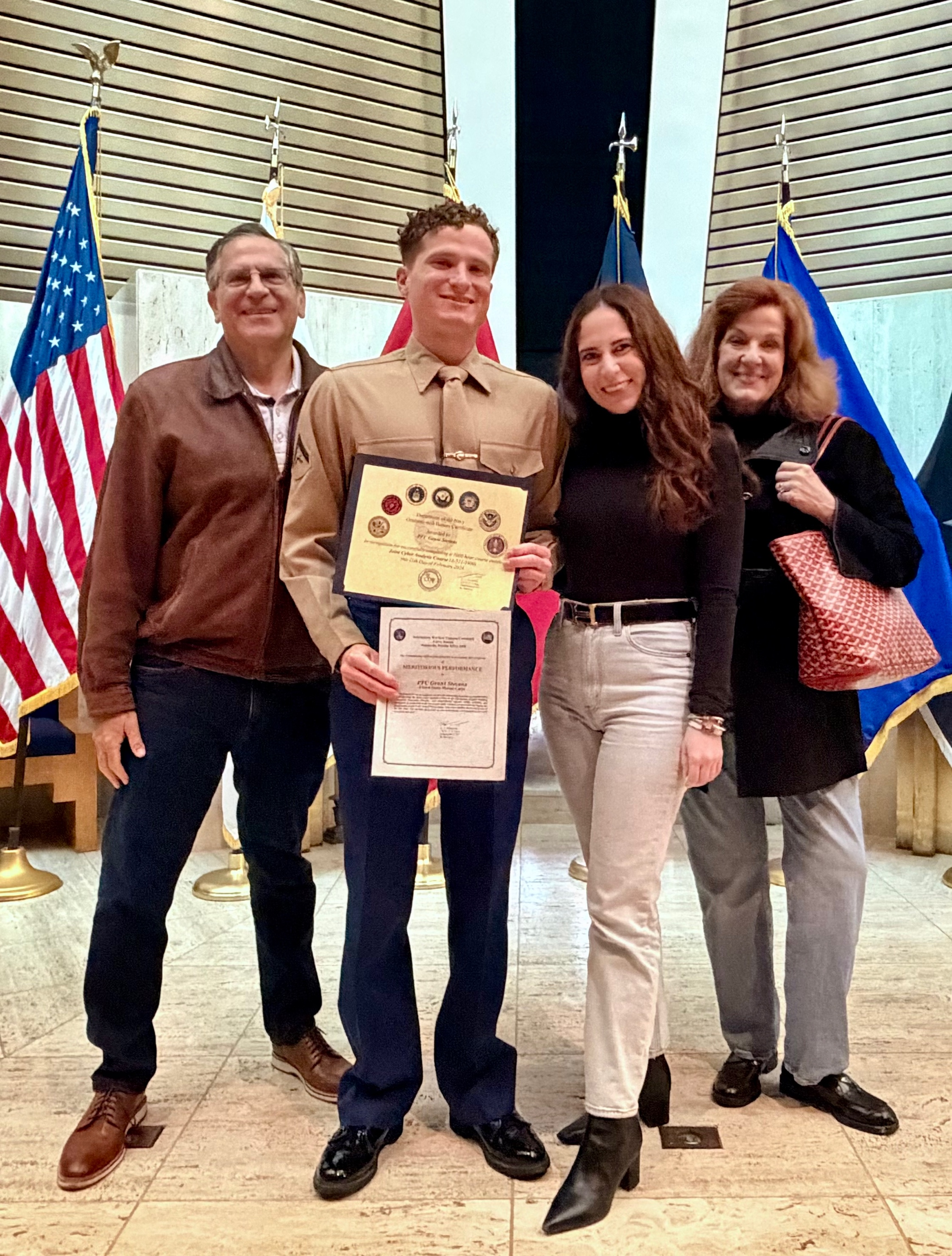 A group of people posing for a photo

Description automatically generated