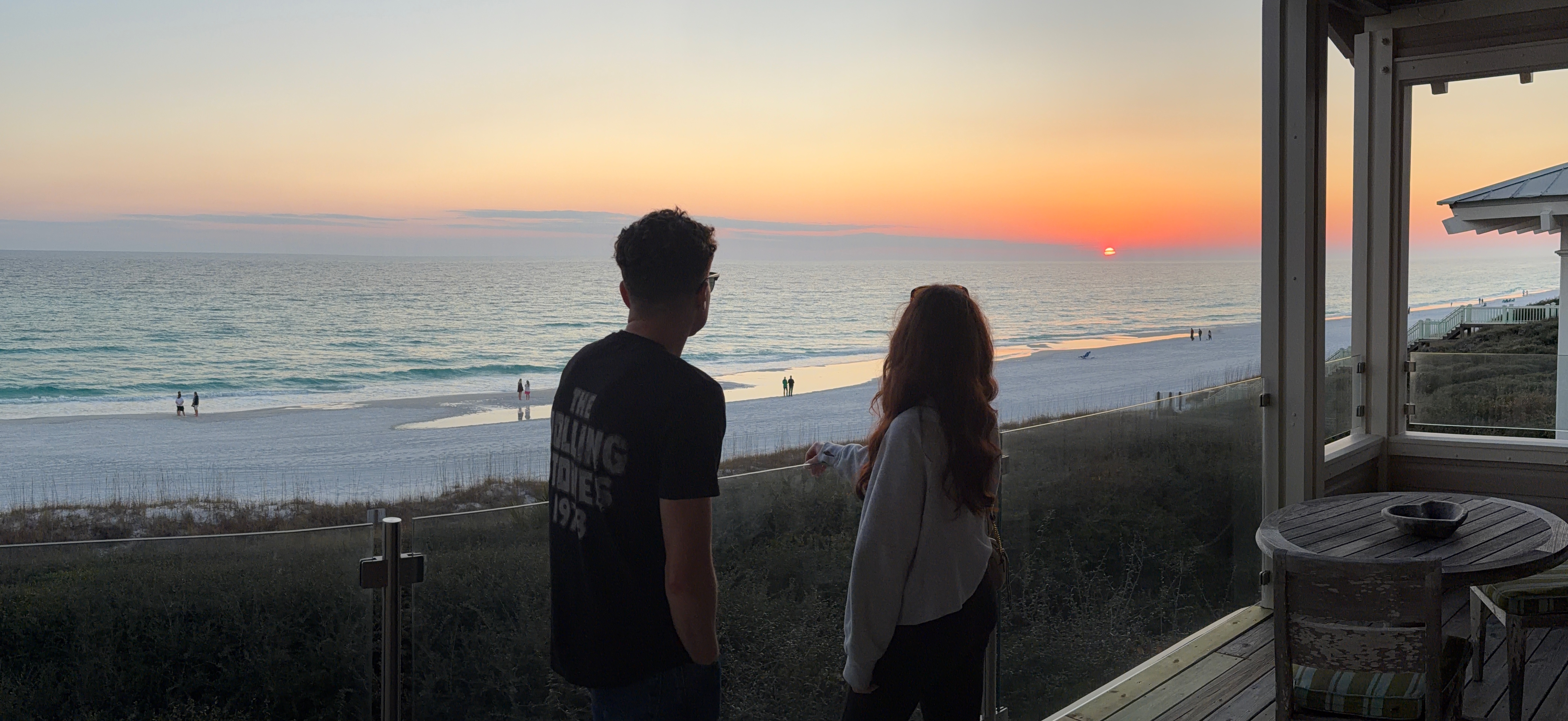 A person and person looking at the ocean

Description automatically generated