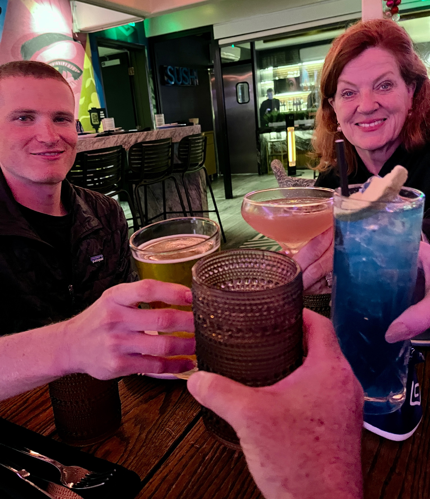 A group of people holding drinks
Description automatically generated